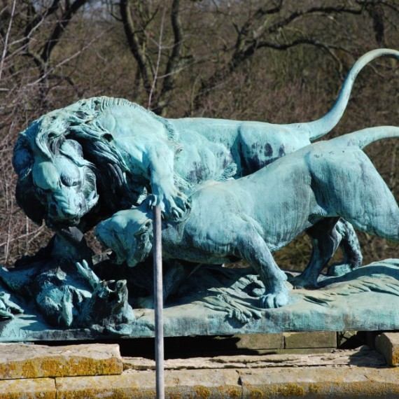 Harlaxton Front Circle, bronze lion and eroded stone base before conservation