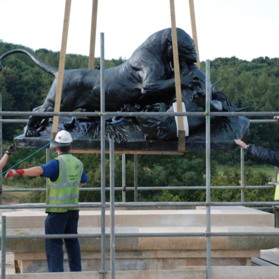 Harlaxton Front Circle, bronze lion being eased back into position