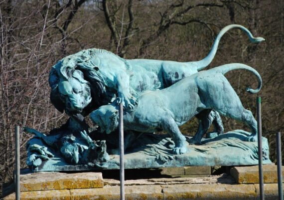 Harlaxton Front Circle, bronze lion and eroded stone base before conservation