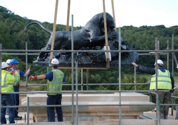 Harlaxton Front Circle, bronze lion being eased back into position